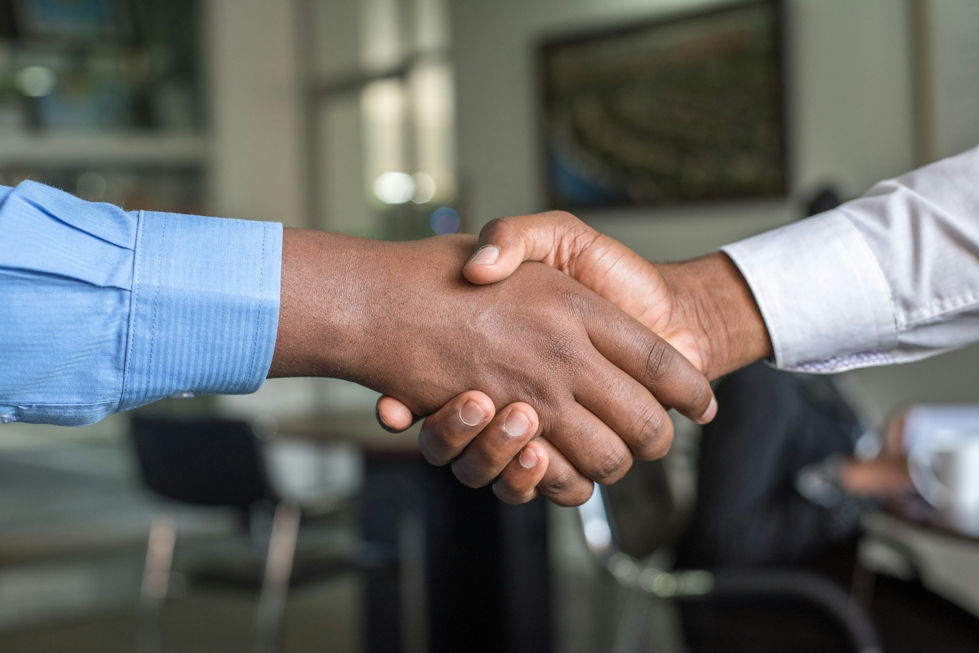 Two investors shaking hands on a deal